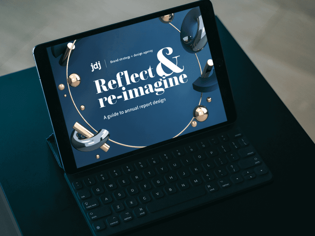 Annual Report Design Guide on laptop computer