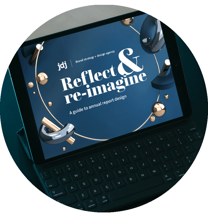 The JDJ Creative annual report design guide displayed on a laptop screen